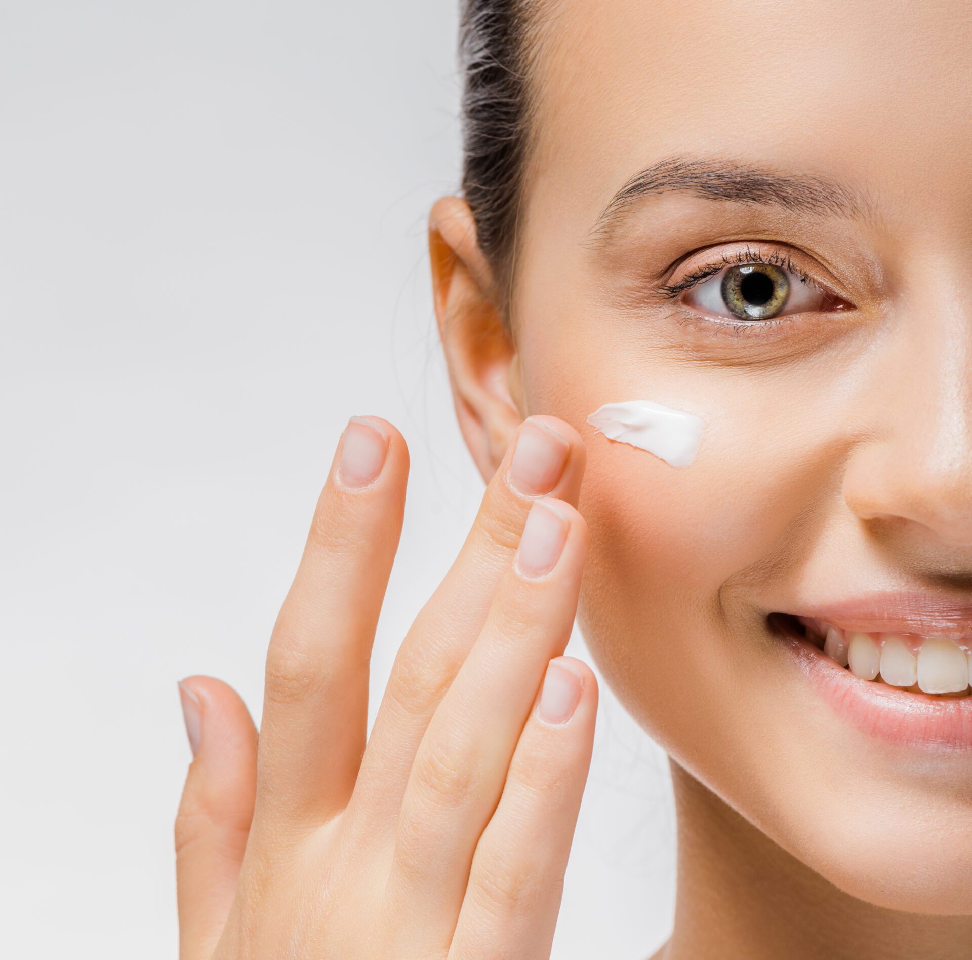 Lady applying cream on face Lady applying cream on face